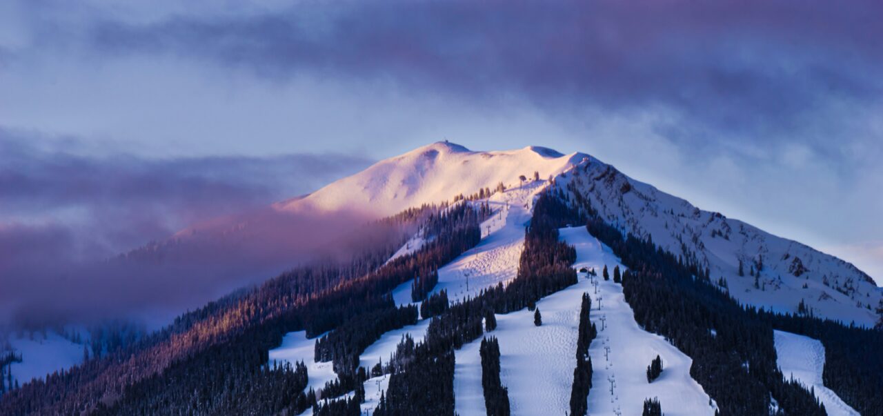 snow on mountains in dusk